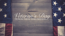 The Flag Of The United Sates Of America On A Grey Plank Background With Veterans Day Greeting