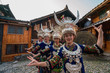 © Westend61 - China, Guizhou, Miao women wearing traditional dresses and headdresses posing on village square