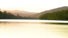 Daintree River In Far North Queensland At Sunset With Egrets Flying Low Over The River