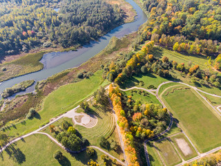 beautiful autumnal scenic landscape. aerial top view of autumnal park with trees, lawns and river