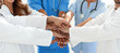 © ASDF - Doctors and nurses stacking hands. concept of mutual aid.