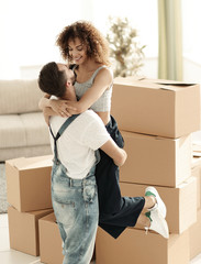 Wall Mural - Hugging couple, against the background of boxes