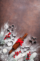 Wall Mural - Bakery background for cooking christmas baking with rolling pin and scattered flour decorated with fir tree top view.