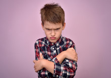 Angry And Pouting Cute Young Boy With Crossed Arms