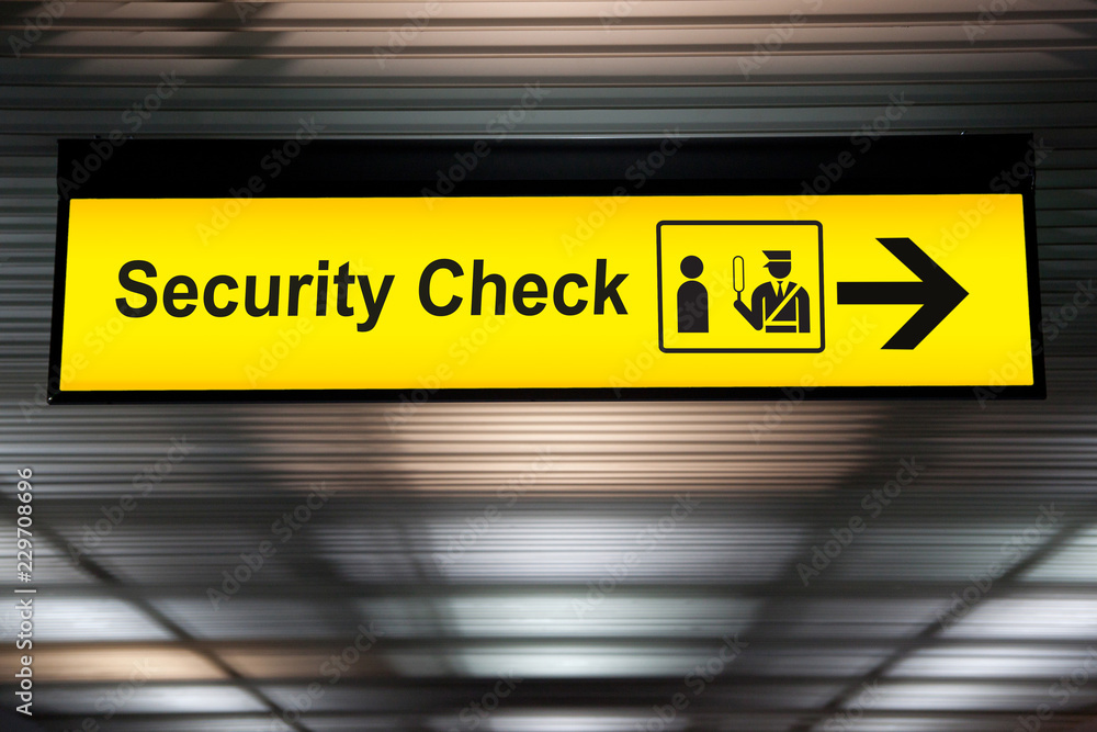 security check sign hanging from airport terminal ceiling - obrazy, fototapety, plakaty 