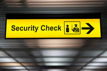 Security Check Sign Hanging From Airport Terminal Ceiling