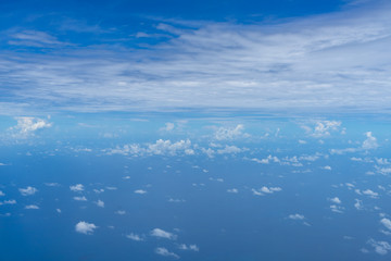 Wall Mural - view of small abstract white cloud with bright blue sky horizon and vast sea ocean background from a