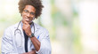 © Krakenimages.com - Afro american doctor man over isolated background looking confident at the camera with smile with crossed arms and hand raised on chin. Thinking positive.