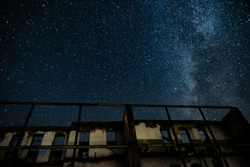 Wall Mural - night sky and the milky way over the old abandoned house