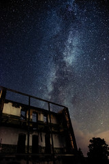 Wall Mural - night sky and the milky way over the old abandoned house