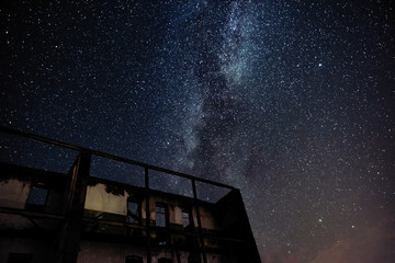 Wall Mural - night sky and the milky way over the old abandoned house