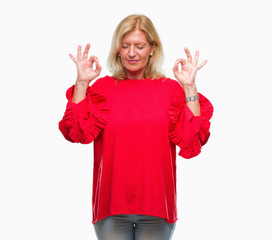 Sticker - Middle age blonde woman over isolated background relax and smiling with eyes closed doing meditation gesture with fingers. Yoga concept.