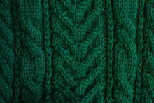 Texture Of Warm Green Knitted Winter Clothes.