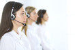 © rogerphoto - Group of call center operators at work. Focus on beautiful business woman in headset