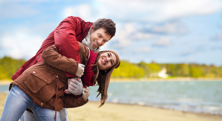 Sticker - love, relationships and people concept - happy teenage couple having fun over autumn beach background