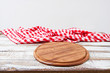 © paulcannoby - Top view wrinkled red tablecloth and plank on wooden table, mock up