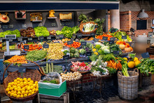 Variety Of Beautifully Organized Fruits And Vegetables On The Counter Of The Market Place