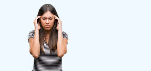 Poster - Young beautiful hispanic woman with hand on head for pain in head because stress. Suffering migraine.