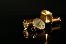 Golden Spyglass With Compass On Black Background