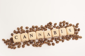 Wall Mural - Alphabet cubes with cannabis seeds on white background