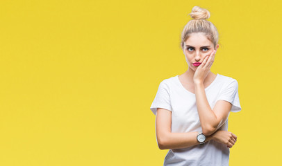 Canvas Print - Young beautiful blonde woman wearing white t-shirt over isolated background thinking looking tired and bored with depression problems with crossed arms.