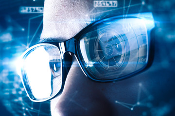 The abstract image of the businessman wear a smart glasses overlay with futuristic hologram. The concept of modern life, technology, iris scanner and internet of things