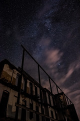 Wall Mural - night sky and the milky way over the old abandoned house