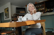 © goodluz - Elegant senior woman thinking in a restaurant
