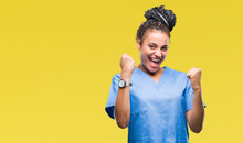 Young Braided Hair African American Girl Professional Nurse Over Isolated Background Very Happy And Excited Doing Winner Gesture With Arms Raised, Smiling And Screaming For Success