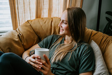Woman Relaxing At Home With Mug
