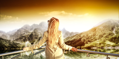 Poster - Slim young blond woman and landscape of mountains with lake. Free space for your decoration. 