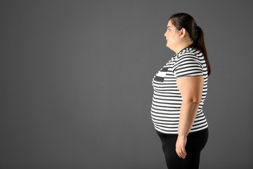 Canvas Print - Portrait of overweight woman and space for text on gray background