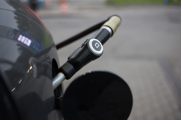 pumping diesel fuel in car at gas station