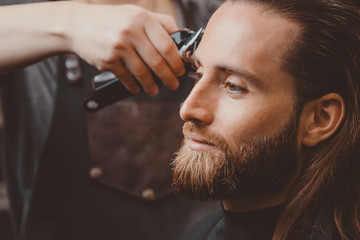 Wall Mural - Hairdresser for men barber shop. Process of cutting long hair.