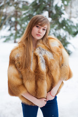 Beautiful elegant brunette woman wearing fur coat