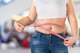 Fototapeta Panele - Overweight, fat woman measuring her stomach on
