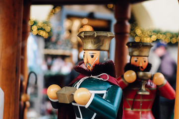 Wall Mural - Wooden crib figurines of the three kings, maria and joseph of traditional German Glockenspiel, a christmas decoration, at the Christkindles Market in Nuremberg, Bavaria during snow in December