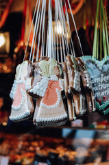 Wall Mural - Traditional German Gingerbread heart, so called Lebkuchenkerz, a baked cookie with sugar icing, hanging at stall at Nuremberg Christmas market sold as gift for loved ones or souvenir