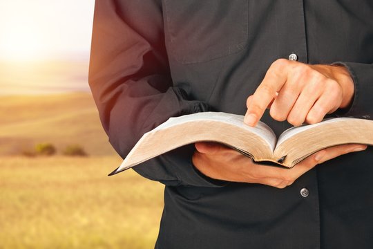 Man reading Bible on  background