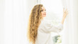 © pic for you - Young women are relaxing after waking up in the morning.Young woman stand up looking at the window relaxing in her bedroom