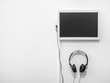 © tete_escape - Blank monitor and headphone on white wall