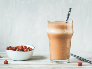 Hazelnut protein shake in a glass. The concept of a healthy lifestyle and fitness diet.