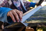Fototapeta Desenie - Man is weaving very fancy multi colored wool using a wooden loom - 4/6 - Closeup picture showing the different colors of the wool