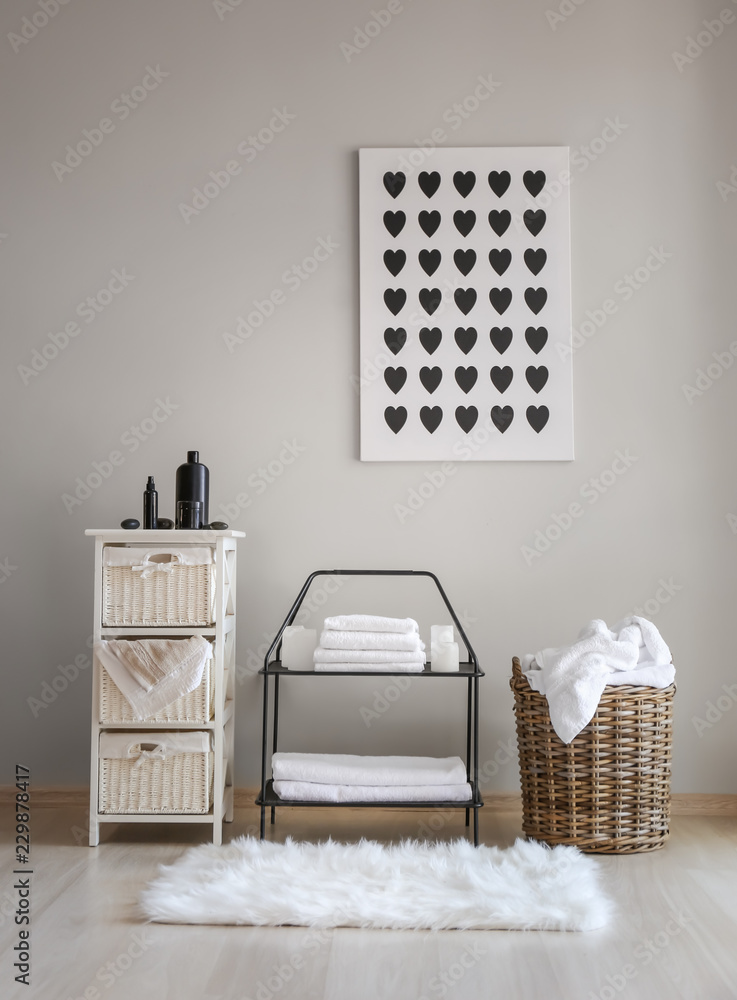 Wicker baskets with dirty laundry and folded clean towels on shelves