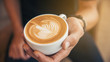 © aFotostock - Late art a cup of coffee on barista hands. young hipster love coffee