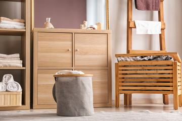 Poster - Laundry basket with dirty towels on floor in bathroom