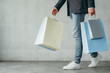 © golubovy - shopping addict and consumerism lifestyle concept. casual man walking holding lots of bags with goods.