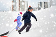 © Syda Productions - childhood, sledging and season concept - happy little kids with sleds climbing snow hill in winter