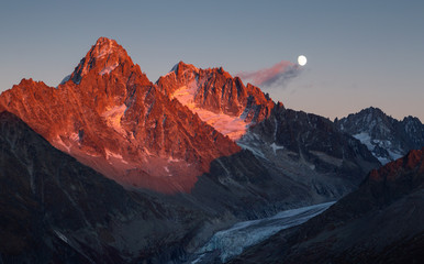 Fototapete - The last sunlight on mountain peak Aiguille D'Argentiere during moonrise. Chamonix, France.