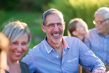 Family picnic. Focus on a handsome man looking at camera